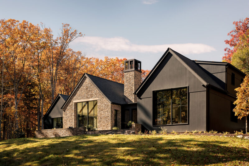 Exterior architecture of a modern home with black wood siding located in the Poconos.