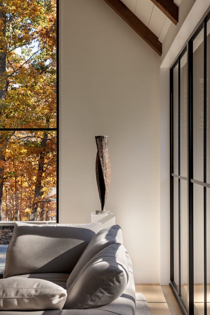 Interior design of a living room with fall leaves outside located in the Poconos.
