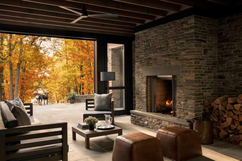 A modern outdoor living space overlooking a lake located in the Poconos.