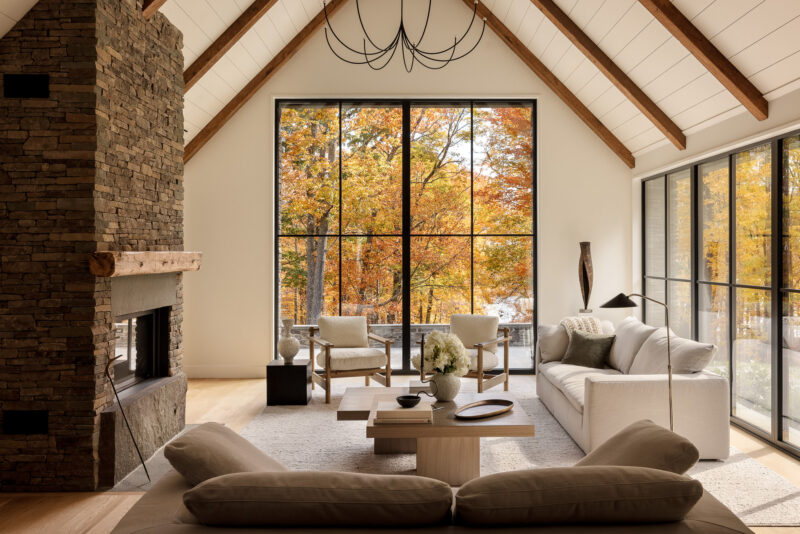 Interior design of a living room with fall leaves outside located in the Poconos.