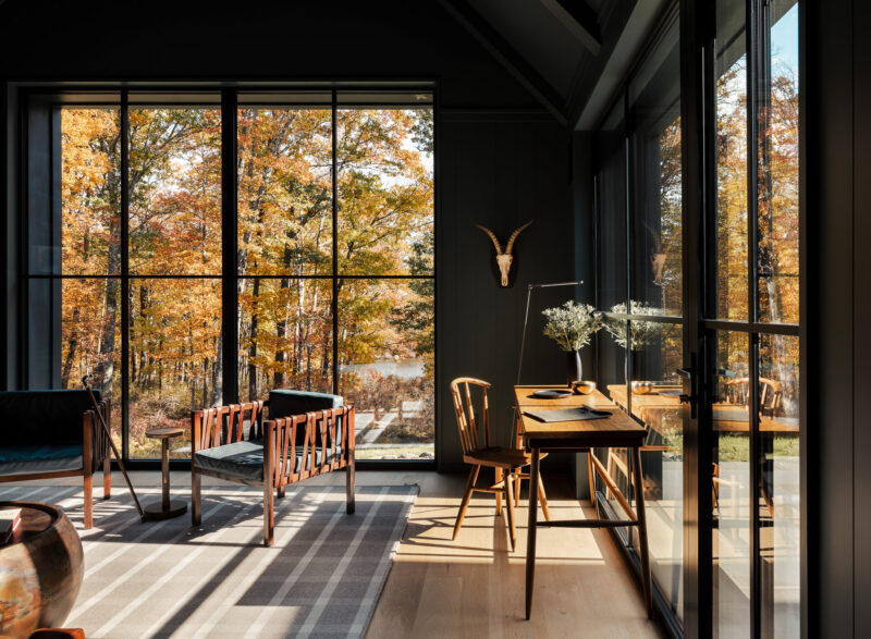 Interior design of a modern office with fall leaves outside located in the Poconos.