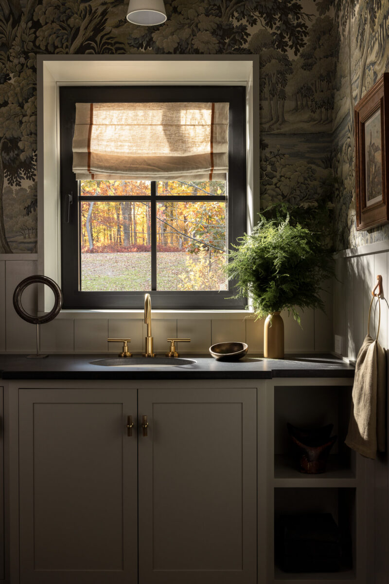 Interior design of a modern powder room with dramatic lighting located in the Poconos.