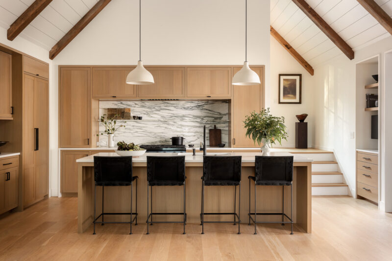 Interior design of a modern kitchen with black hardware located in the Poconos.