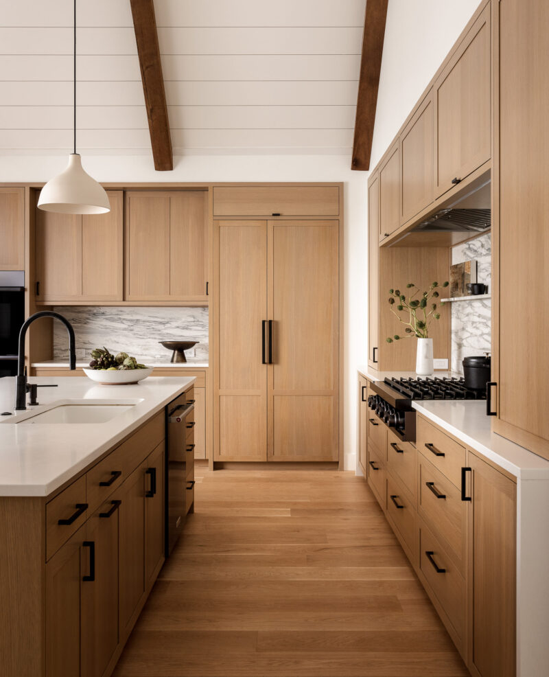 Interior design of a modern kitchen with black hardware located in the Poconos.