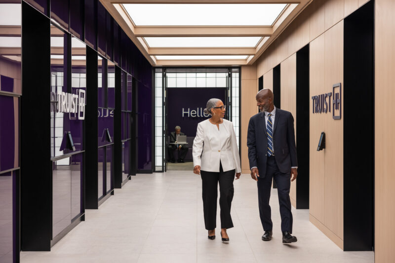 Lifestyle photograph of a man and woman in an elevator lobby