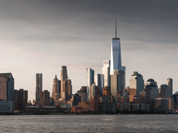 Lower Manhattan cityscape during sunrise with dramatic clouds