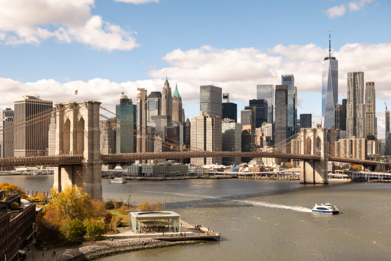 Brooklyn Bridge with colorful Fall leaves captured during a beautiful Fall afternoon.
