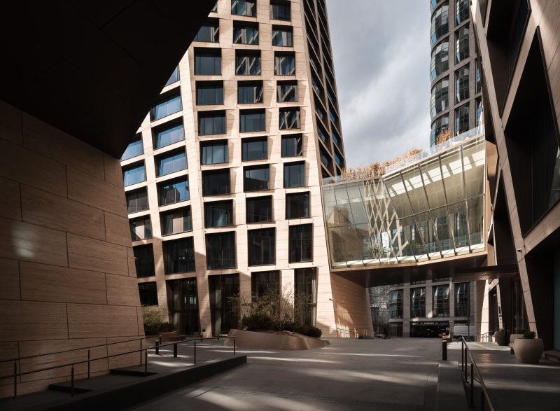 Exterior entrance of One High Line Condominium Residences with dramatic sunlight